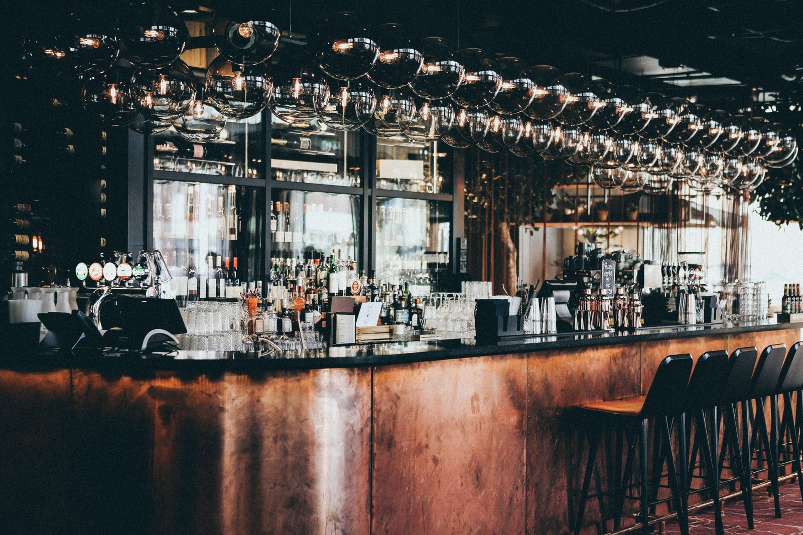 Wide Shot Of Bottles And Glasses In Display Cabinet At A Bar In Scandic Hotel In Copenhagen, Denmark
